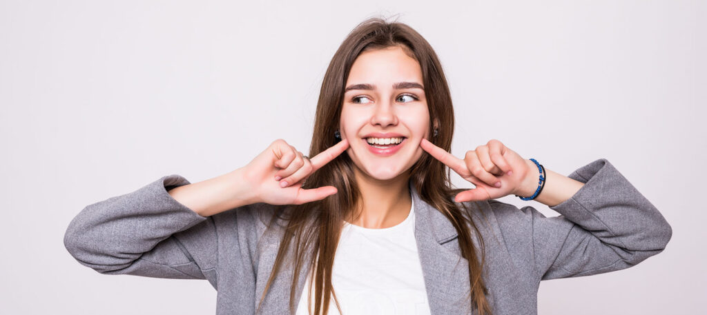adult smiles after watching TikTok Invisalign Hacks