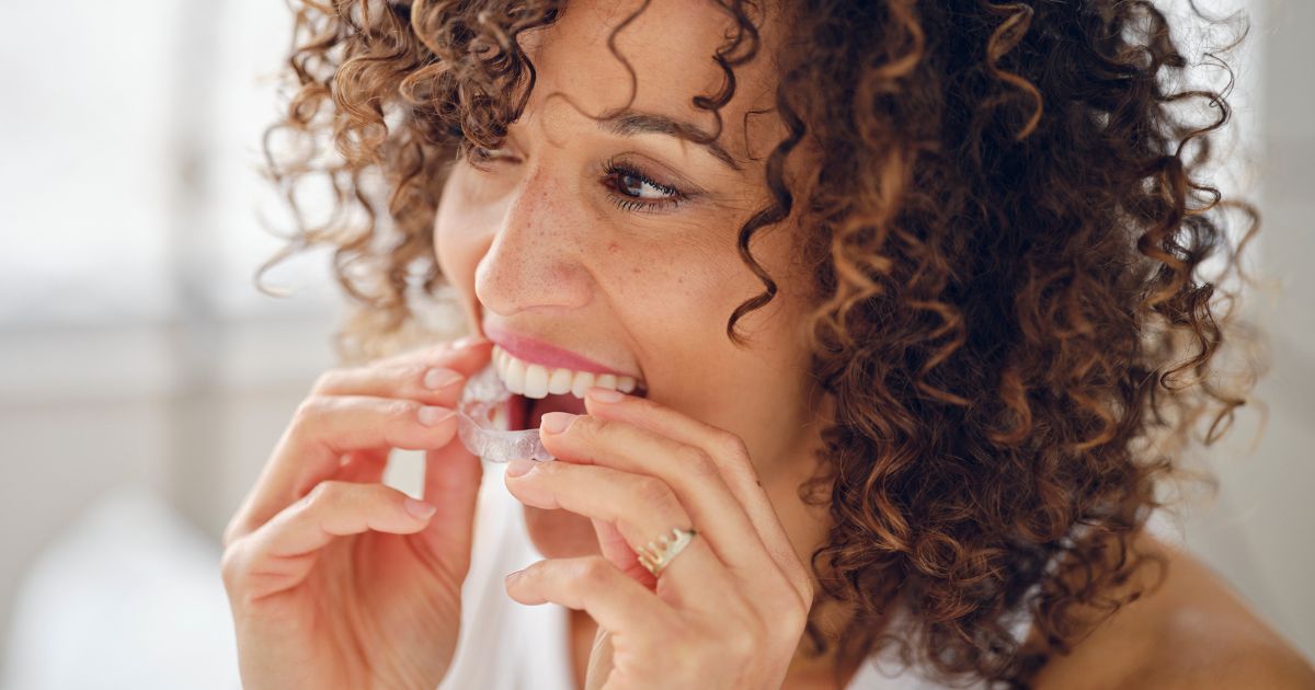 adult putting in retainer wondering How Long Do Retainers Last