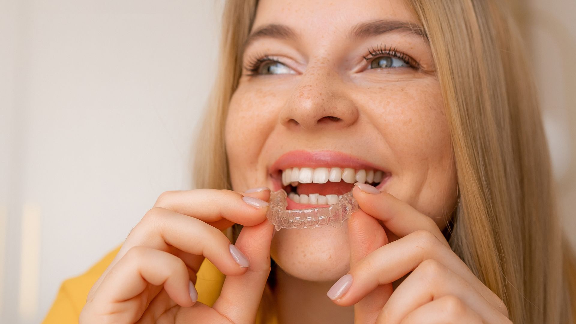 adult holds retainer and wonders How long to wear retainers