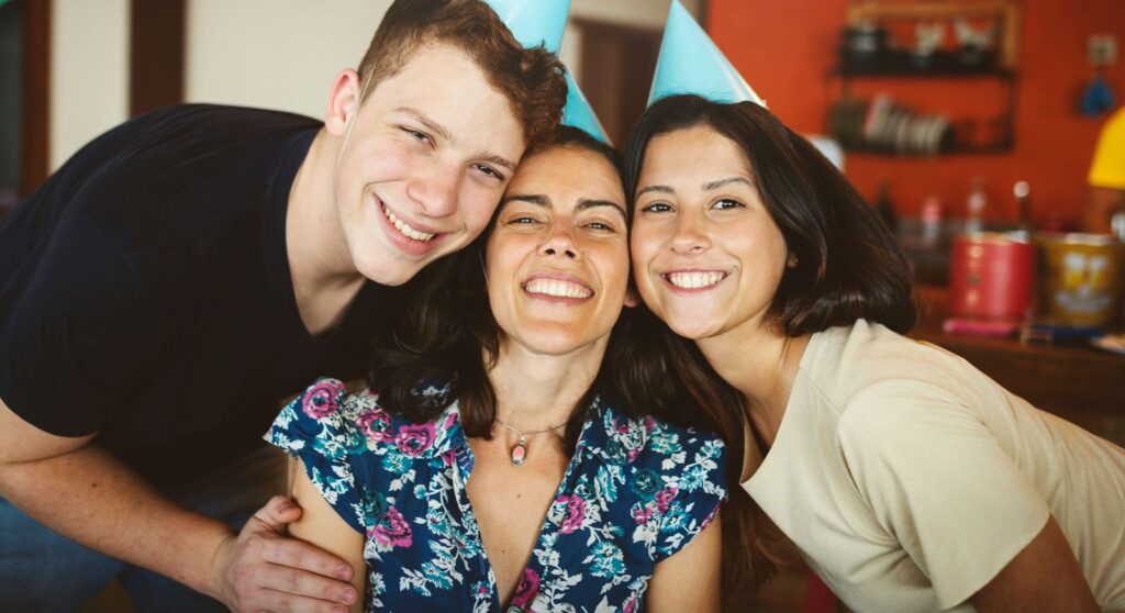 Three friends smiling celebrating the new year